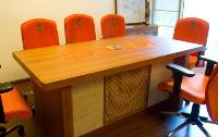 the small conference table on the first floor.hand embroidered motifs on the chairbacks